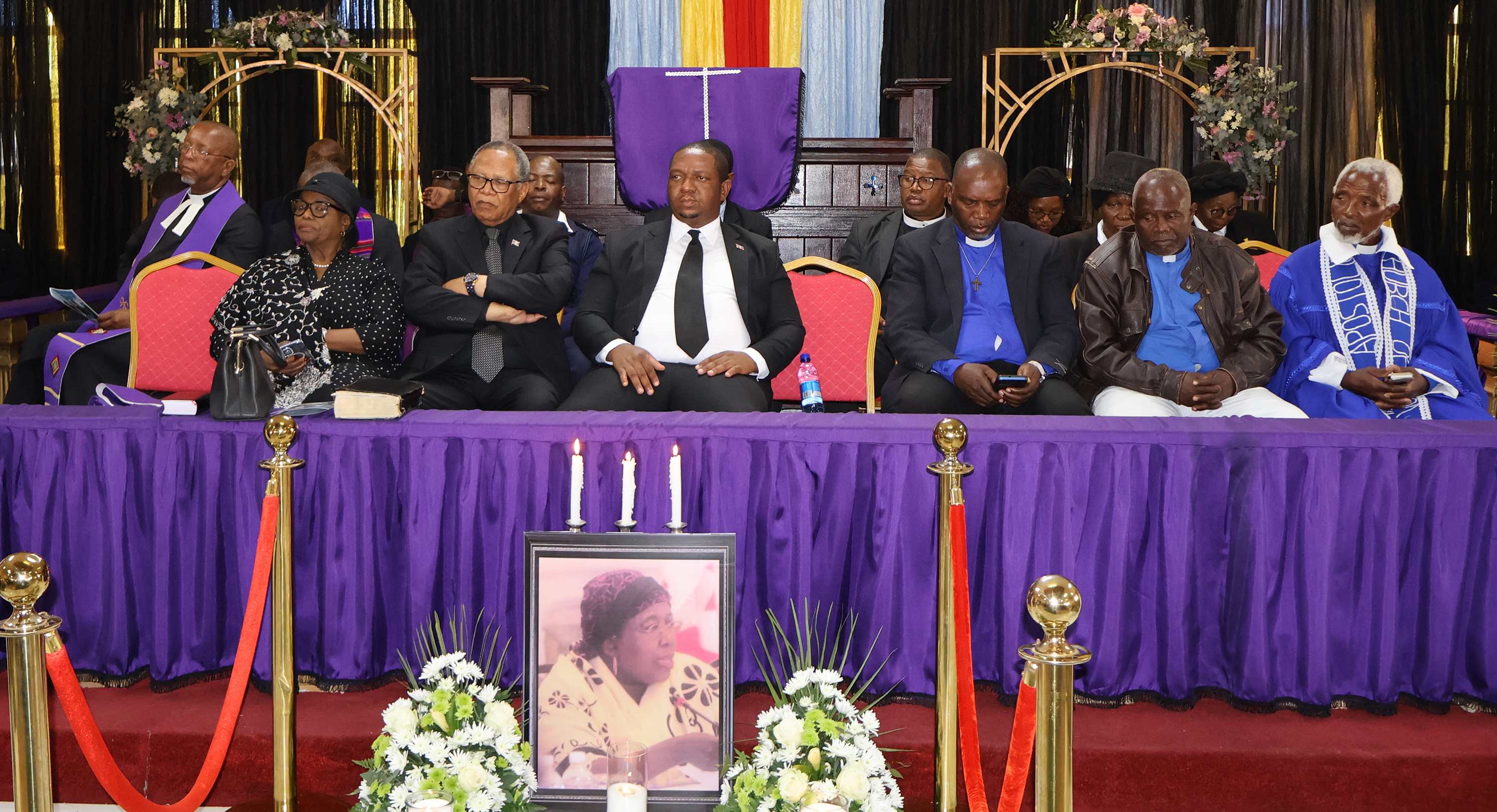 Their Majesties and government representatives Shiselweni RA Themba Masuku (2nd L) and Minister of Labour and Social Security Phila Buthelezi (3rd L) following the proceedings of the late former Senator Constance Simelane’s State memorial service, together with some of the mourners.